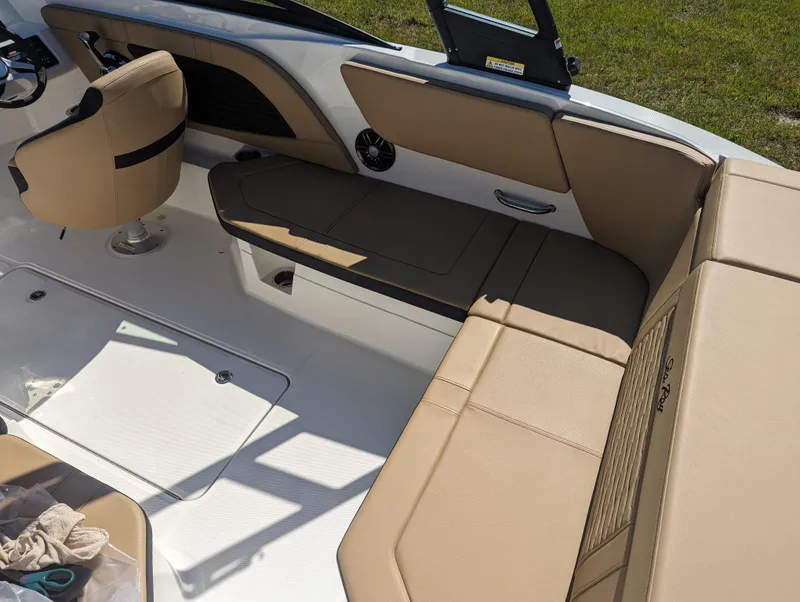 Slide: The Image of 2024 Sea Ray SPX 230 boat interior with tan seating and modern design. - 17