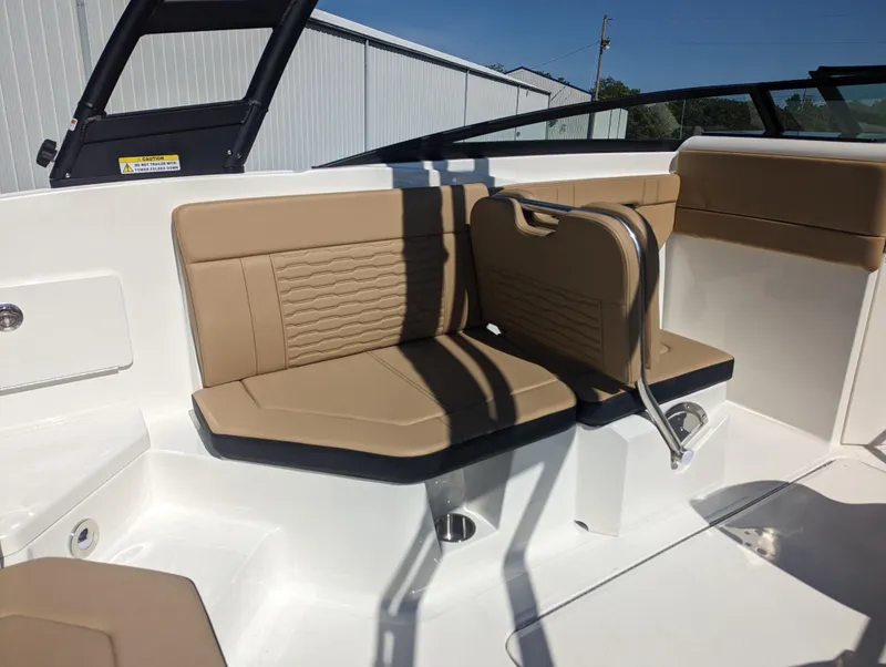 Slide: The Image of 2024 Sea Ray SPX 230 boat interior with tan leather seating and white deck. - 18