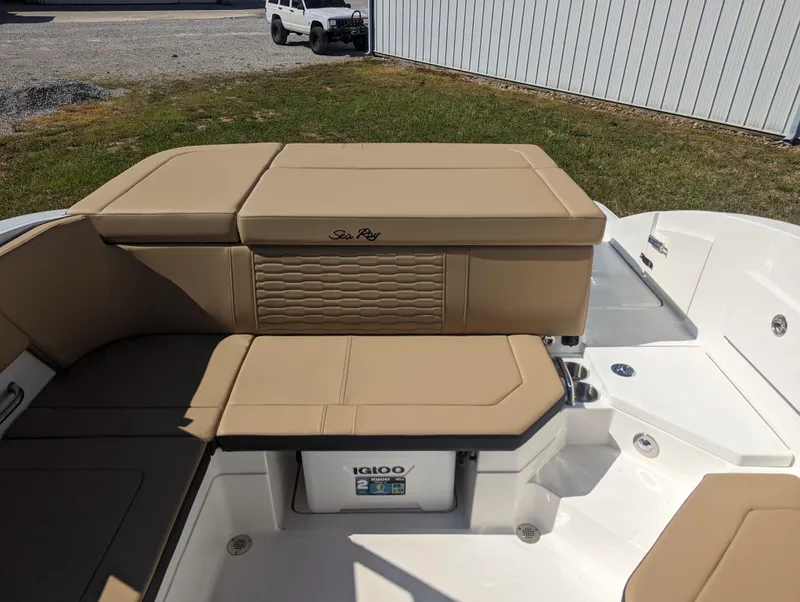Slide: The Image of 2024 Sea Ray SPX 230 boat interior with tan seating and Igloo cooler. - 20