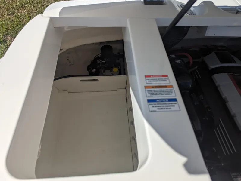 Slide: The Image of 2024 Sea Ray SPX 230 engine compartment with visible components and warning labels. - 23