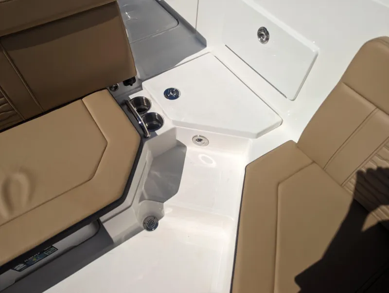 Slide: The Image of 2024 Sea Ray SPX 230 boat interior with tan seating and cup holders. - 24