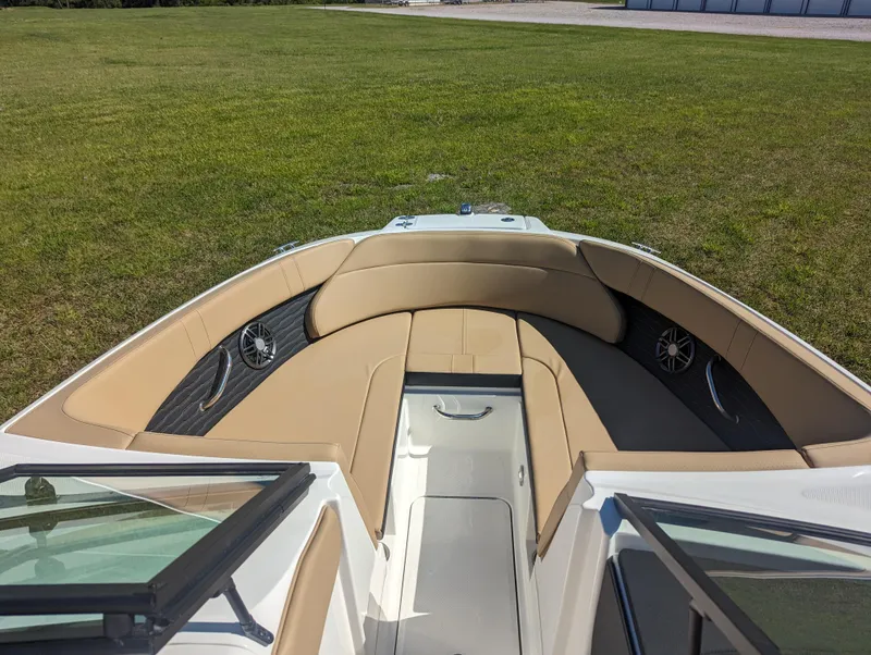 Slide: The Image of 2024 Sea Ray SPX 230 boat interior with tan seating and speakers. - 6