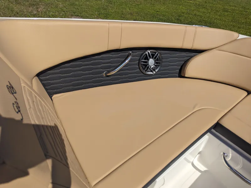 Slide: The Image of 2024 Sea Ray SPX 230 boat interior with tan leather seating and speaker. - 7