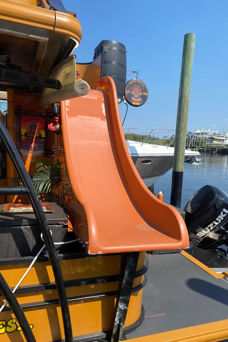 Slide: The Image of Orange slide on Custom Tiki Bahama Mama 2.0 boat, 2024 model, docked at marina. - 6