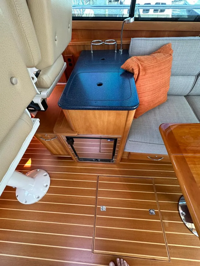 Slide: The Image of Interior of 2012 Sabre 48 Salon Express yacht with wooden flooring and seating area. - 11