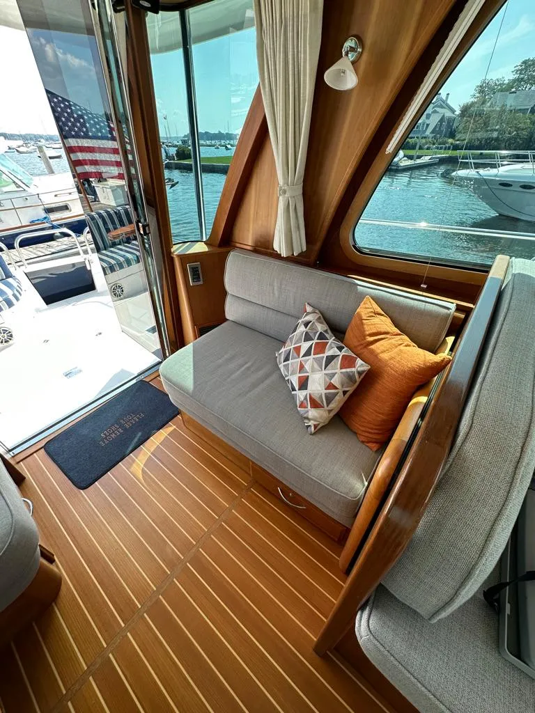Slide: The Image of Interior of 2012 Sabre 48 Salon Express yacht with cozy seating and decorative pillows. - 14