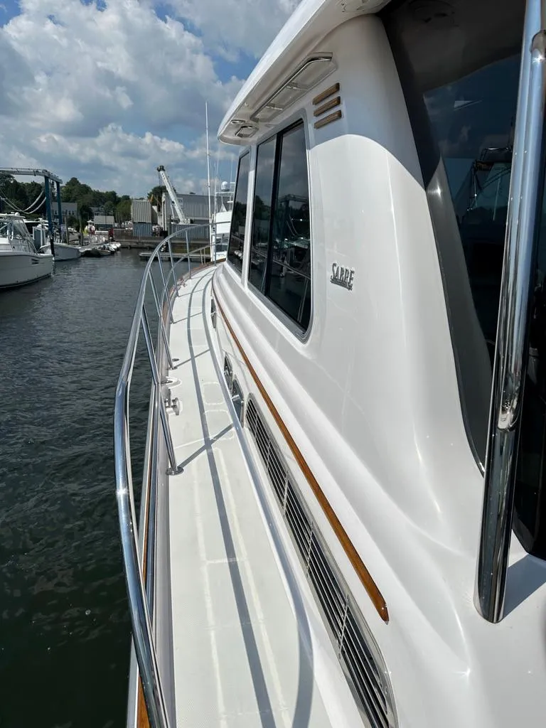 Slide: The Image of 2012 Sabre 48 Salon Express yacht docked at a marina. - 34