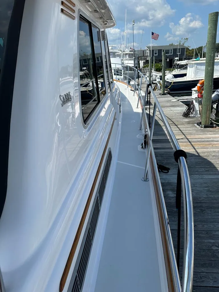 Slide: The Image of 2012 Sabre 48 Salon Express yacht docked at a marina on a sunny day. - 35