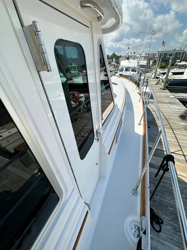 Slide: The Image of 2012 Sabre 48 Salon Express yacht docked at marina. - 36