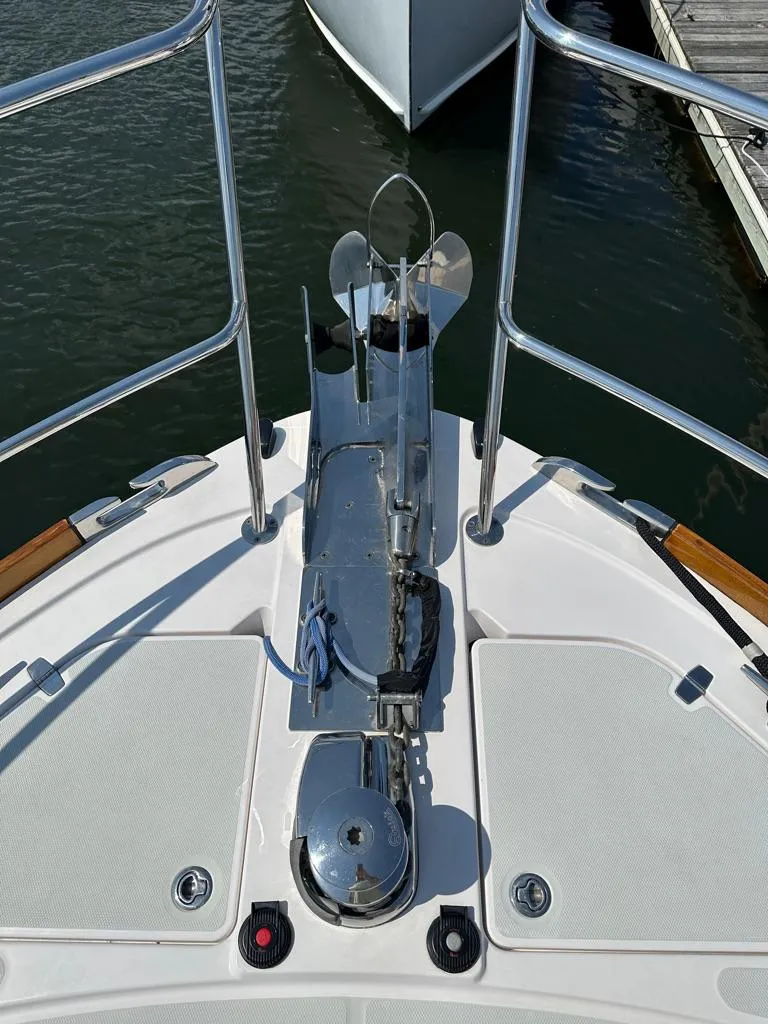 Slide: The Image of Bow of 2012 Sabre 48 Salon Express yacht with anchor and railing. - 38