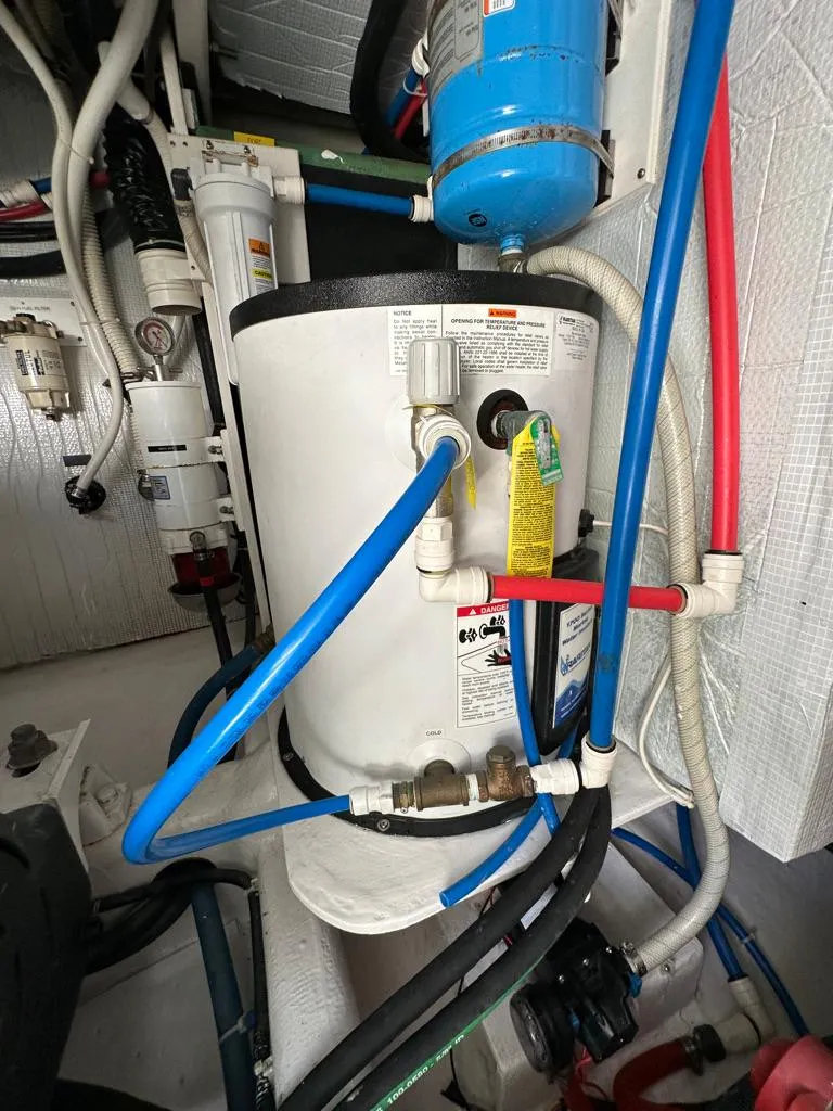 Slide: The Image of Engine room of a 2012 Sabre 48 Salon Express yacht with various mechanical components. - 48