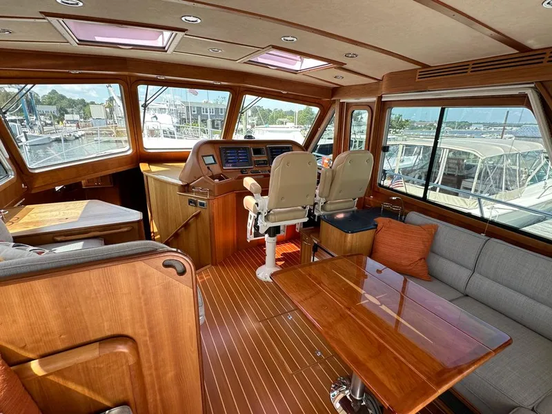 Slide: The Image of Interior of 2012 Sabre 48 Salon Express yacht with helm, seating, and wooden finishes. - 9