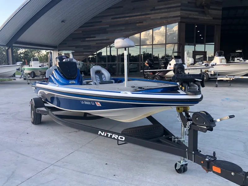 Slide: The Image of 2019 Nitro Z18 boat on trailer in front of a showroom. - 2