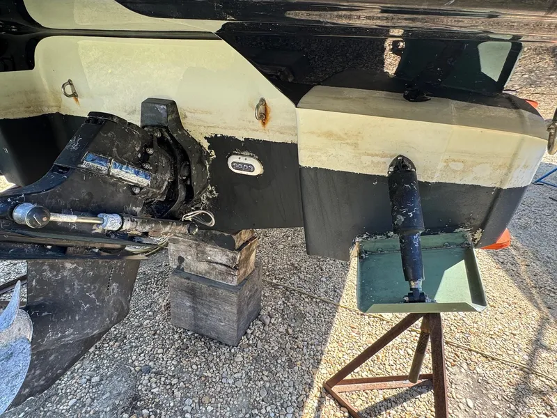 Slide: The Image of Crownline 264CR 2020 boat stern with propeller and rudder, on dry dock. - 11