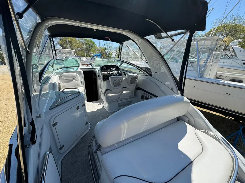 Slide: The Image of 2020 Crownline 264CR boat interior with white seating and modern dashboard. - 21