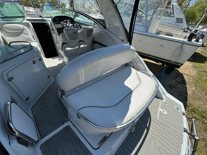 Slide: The Image of 2020 Crownline 264CR boat interior with white seating and modern dashboard. - 22