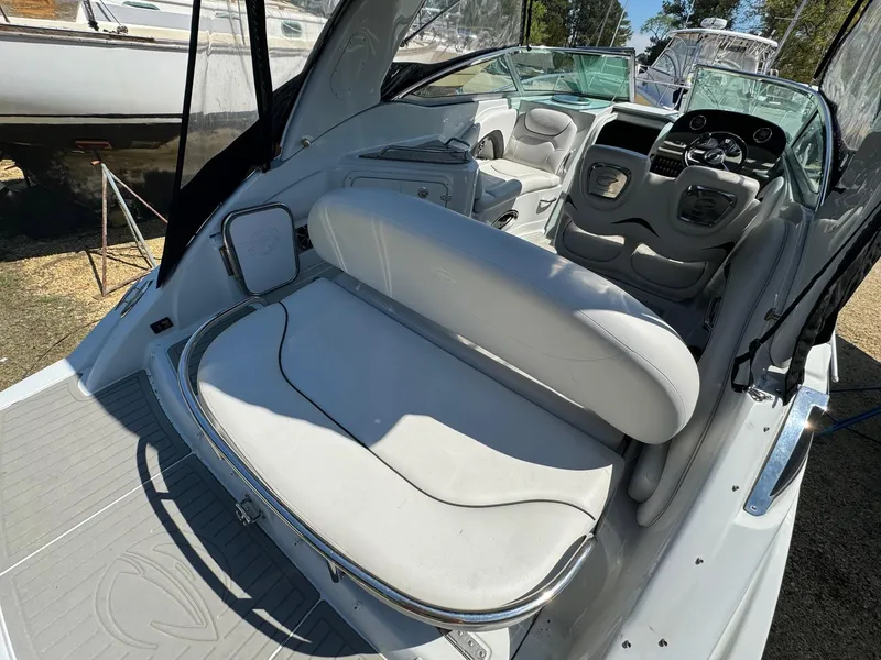 Slide: The Image of 2020 Crownline 264CR boat interior with white seating and dashboard. - 23