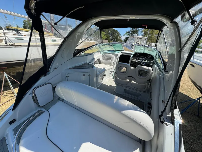 Slide: The Image of 2020 Crownline 264CR boat interior with white seating and modern dashboard. - 24