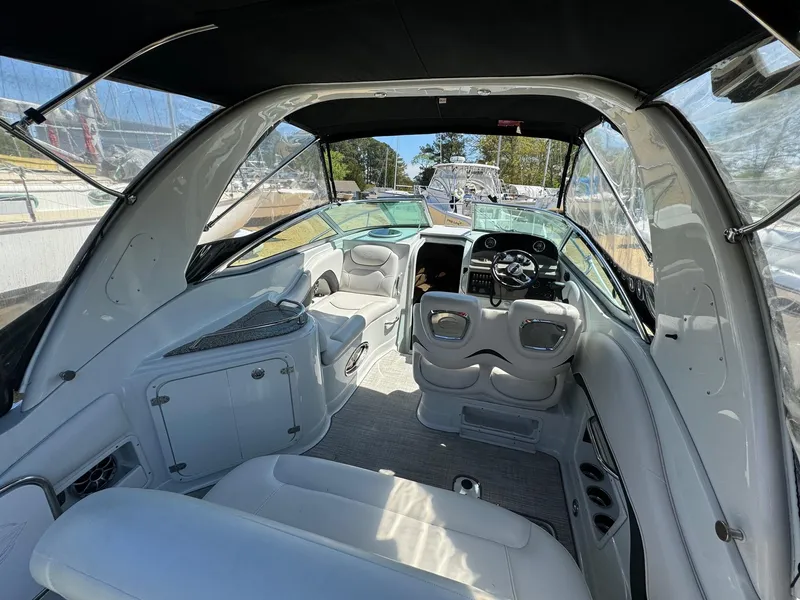 Slide: The Image of Interior of 2020 Crownline 264CR boat, featuring sleek seating and modern dashboard. - 25