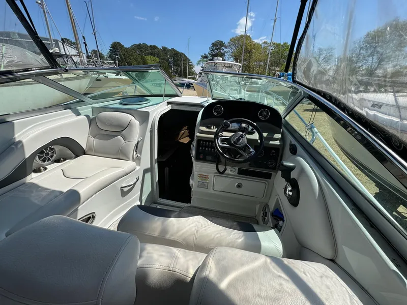 Slide: The Image of 2020 Crownline 264CR boat interior with steering wheel and seating area. - 27