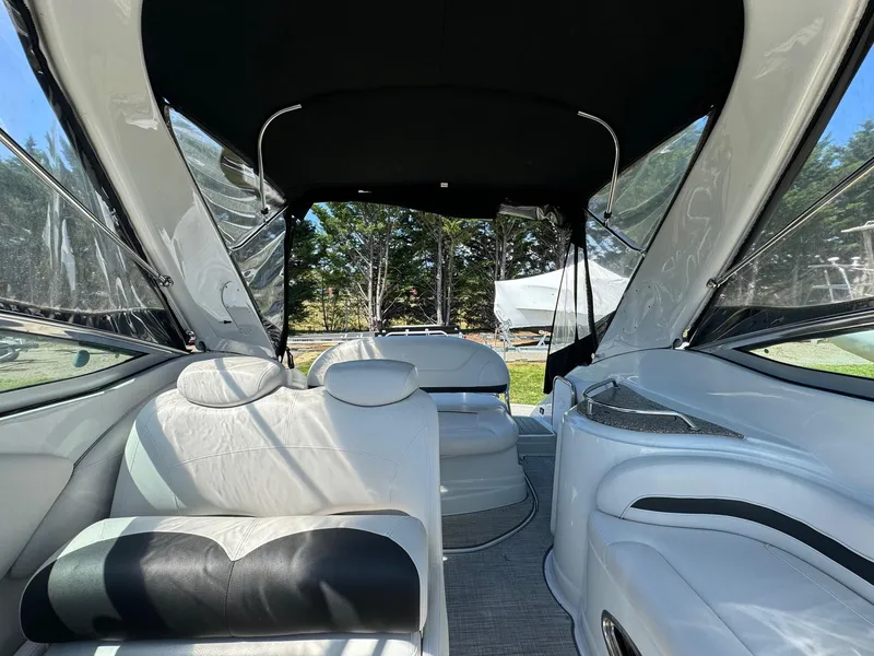 Slide: The Image of Interior of 2020 Crownline 264CR boat with white seating and canopy. - 38