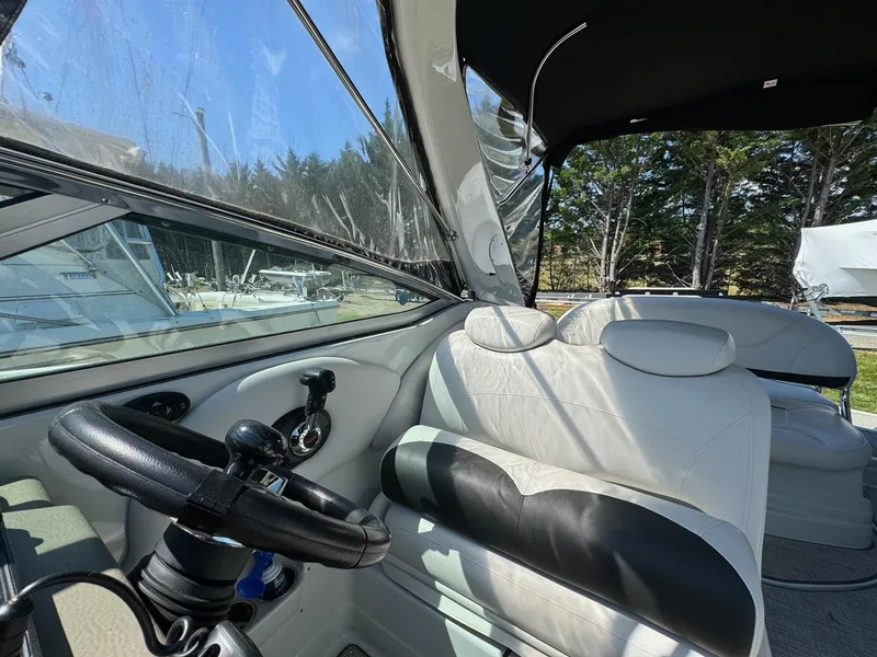 Slide: The Image of Interior of 2020 Crownline 264CR boat with steering wheel and seating. - 39