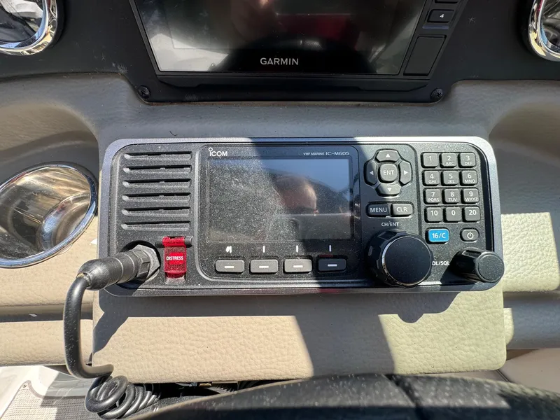 Slide: The Image of ICOM marine radio on 2020 Crownline 264CR boat dashboard. - 47