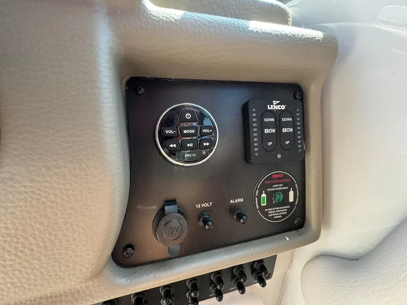 Slide: The Image of Control panel of 2020 Crownline 264CR boat with audio and trim controls. - 49