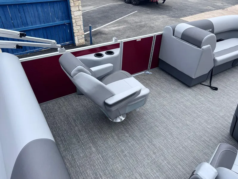 Slide: The Image of 2024 Bennington 22SV pontoon boat interior with gray seating and red paneling. - 11