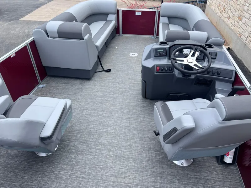 Slide: The Image of 2024 Bennington 22SV pontoon boat interior with gray seating and steering console. - 6