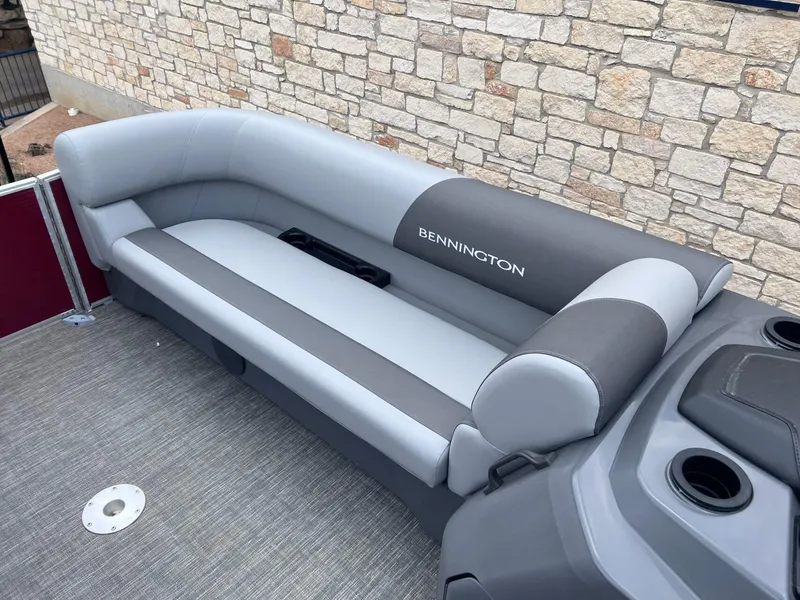 Slide: The Image of 2024 Bennington 22SV boat interior with gray seating and cup holders. - 8
