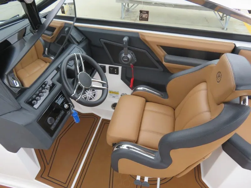 Slide: The Image of 2023 Cobalt R6 Surf boat interior with tan and black seating, steering wheel, and control panel. - 7