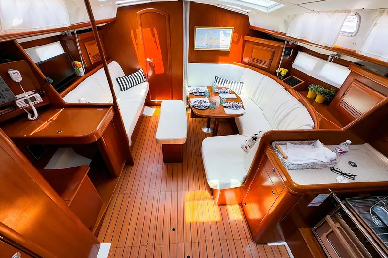 Slide: The Image of Luxurious interior of 2005 Beneteau 423 yacht with elegant wood finish and cozy seating. - 12