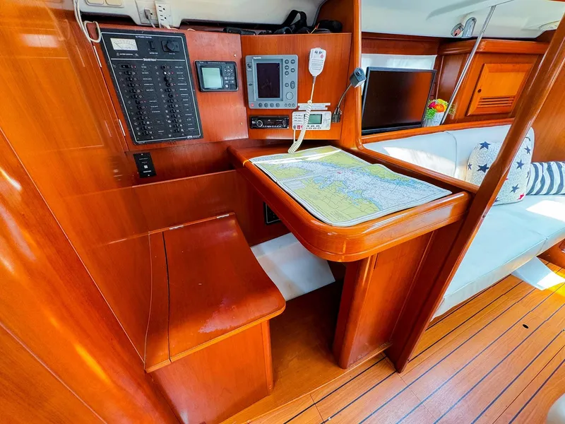 Slide: The Image of Interior of 2005 Beneteau 423 sailboat with navigation station and wooden finish. - 15
