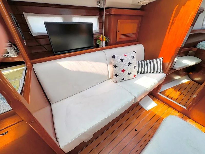 Slide: The Image of Interior of 2005 Beneteau 423 yacht with white sofa and decorative pillows. - 17