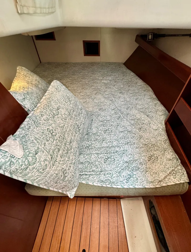 Slide: The Image of Cozy cabin interior of 2005 Beneteau 423 sailboat with patterned bedding. - 19