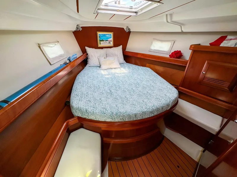 Slide: The Image of Luxurious cabin interior of 2005 Beneteau 423 sailboat with cozy bed and wooden finish. - 21