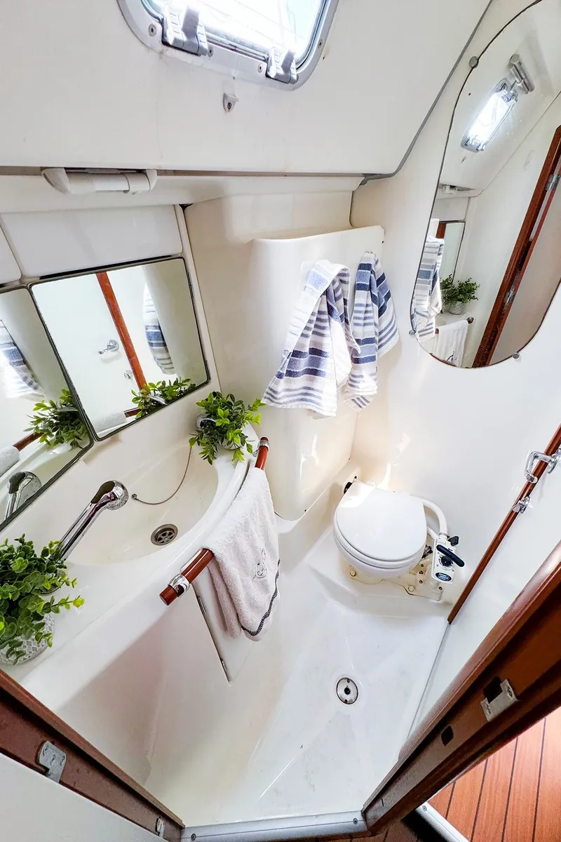 Slide: The Image of Beneteau 423 2005 yacht bathroom with modern fixtures and nautical decor. - 22