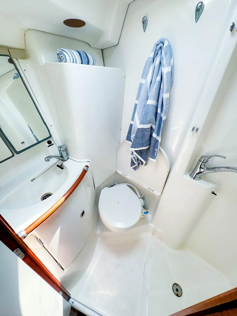 Slide: The Image of 2005 Beneteau 423 yacht bathroom with sink, toilet, and towel. - 24