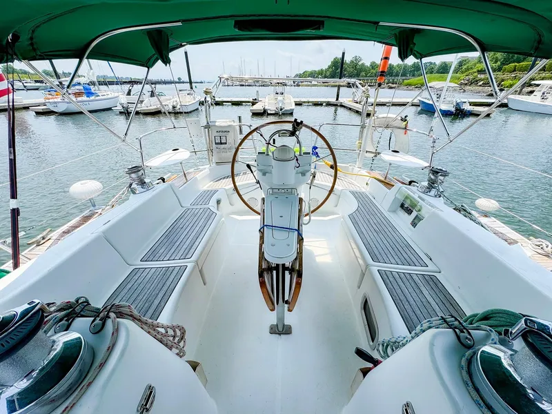 Slide: The Image of Beneteau 423 sailboat cockpit, 2005 model, docked at marina with green canopy. - 8
