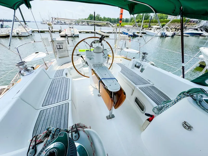 Slide: The Image of Beneteau 423 sailboat cockpit, 2005 model, docked at marina with green canopy. - 9
