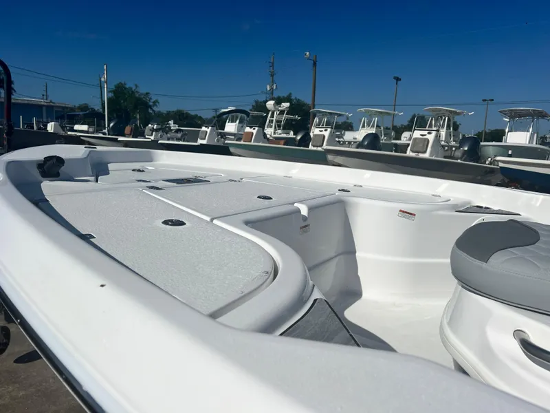 Slide: The Image of 2024 NauticStar 194 Bay boat interior, white deck, and seating area. - 3