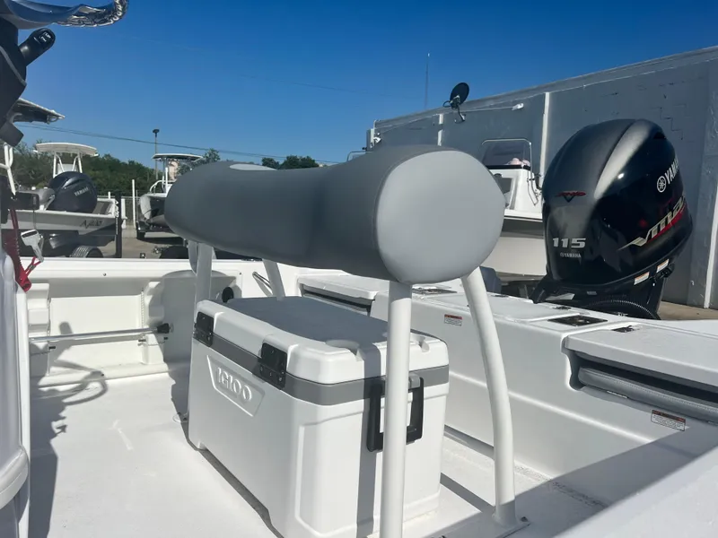 Slide: The Image of 2024 NauticStar 194 Bay boat interior with seating and Yamaha 115 outboard motor. - 4