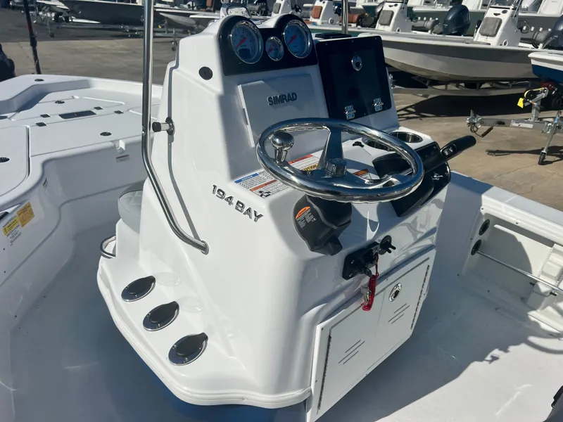 Slide: The Image of 2024 NauticStar 194 Bay boat console with steering wheel and gauges. - 5