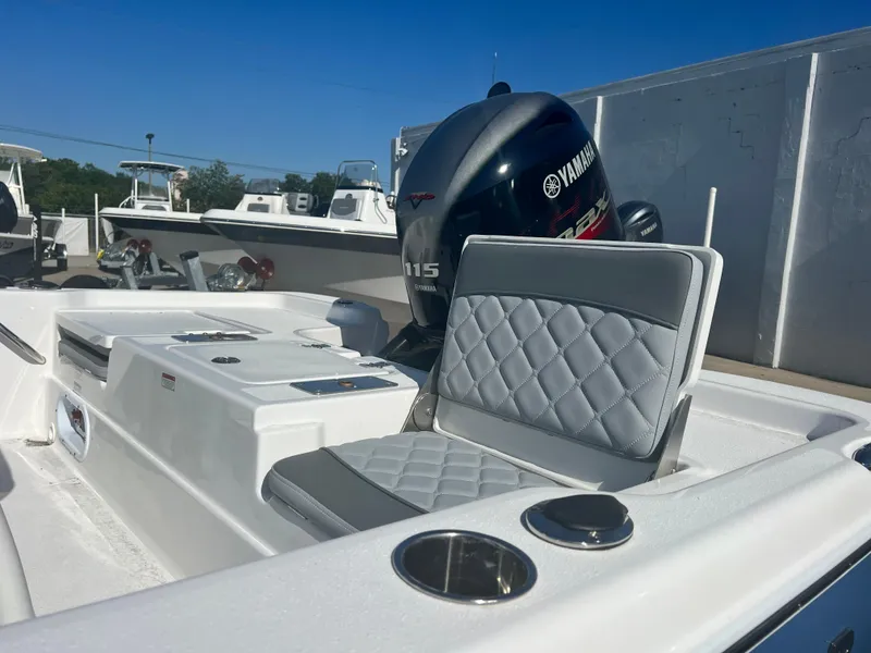 Slide: The Image of 2024 NauticStar 194 Bay boat with Yamaha 115 engine, featuring cushioned seating. - 6