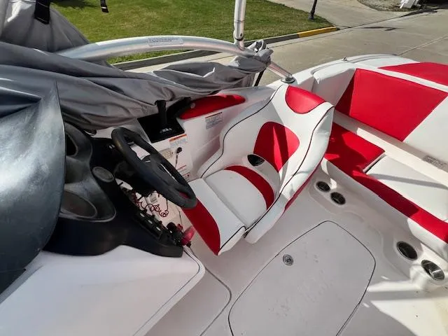 Slide: The Image of 2004 Yamaha Boats AR 210 interior with red and white seating. - 10
