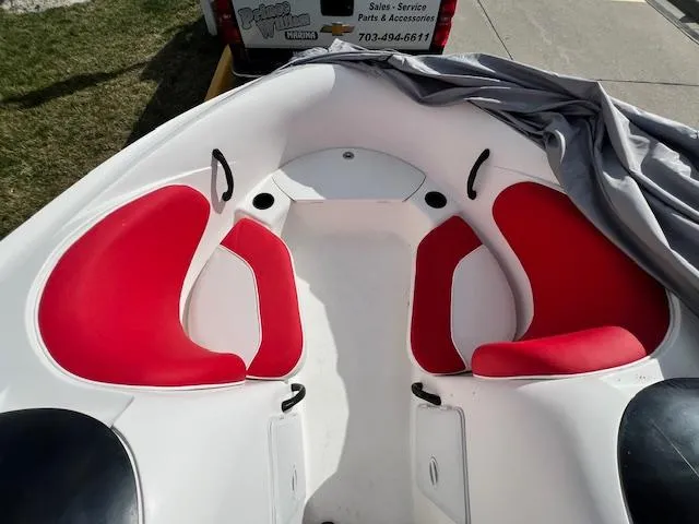 Slide: The Image of 2004 Yamaha Boats AR 210 with red and white seating in the bow area. - 11
