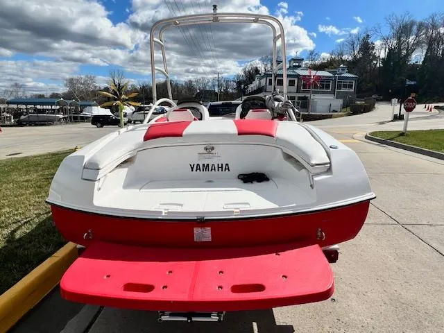 Slide: The Image of 2004 Yamaha Boats AR 210, red and white, docked at marina. - 3