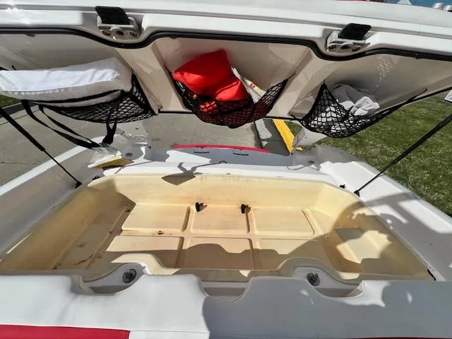 Slide: The Image of Open storage compartment of a 2004 Yamaha Boats AR 210 with safety gear. - 7