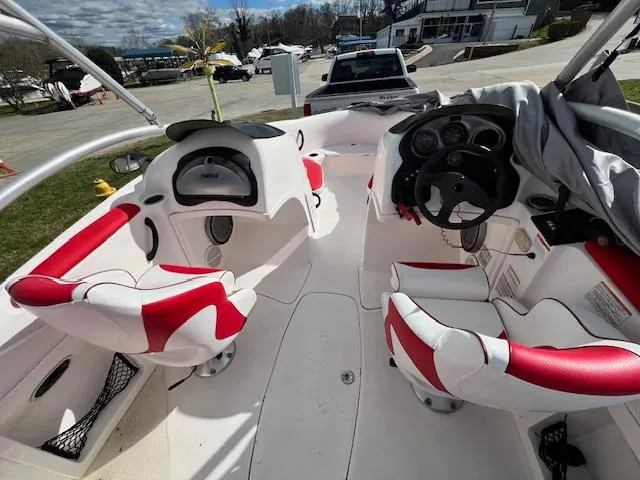 Slide: The Image of 2004 Yamaha Boats AR 210 interior with red and white seating, dashboard, and steering wheel. - 8